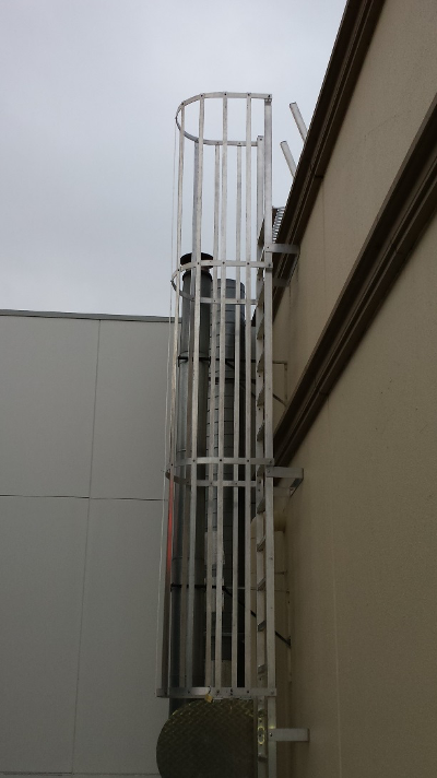 A roof access ladder in Melbourne configured as a caged ladder.